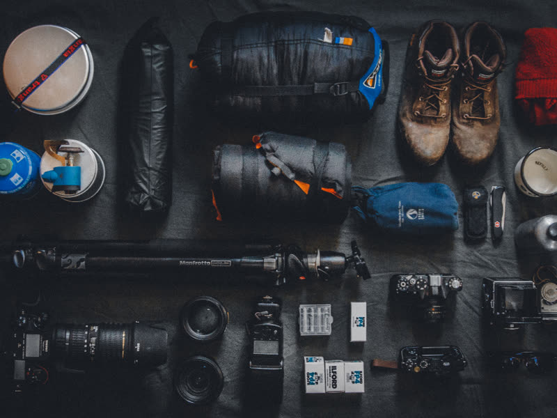Camera bodies and lenses laid out on a dark surface